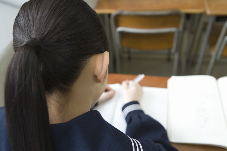 Teenage girl studying at desk
